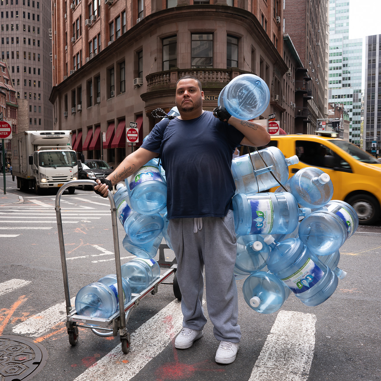 Photo: Man delivering empty water jugs in teh financial district.