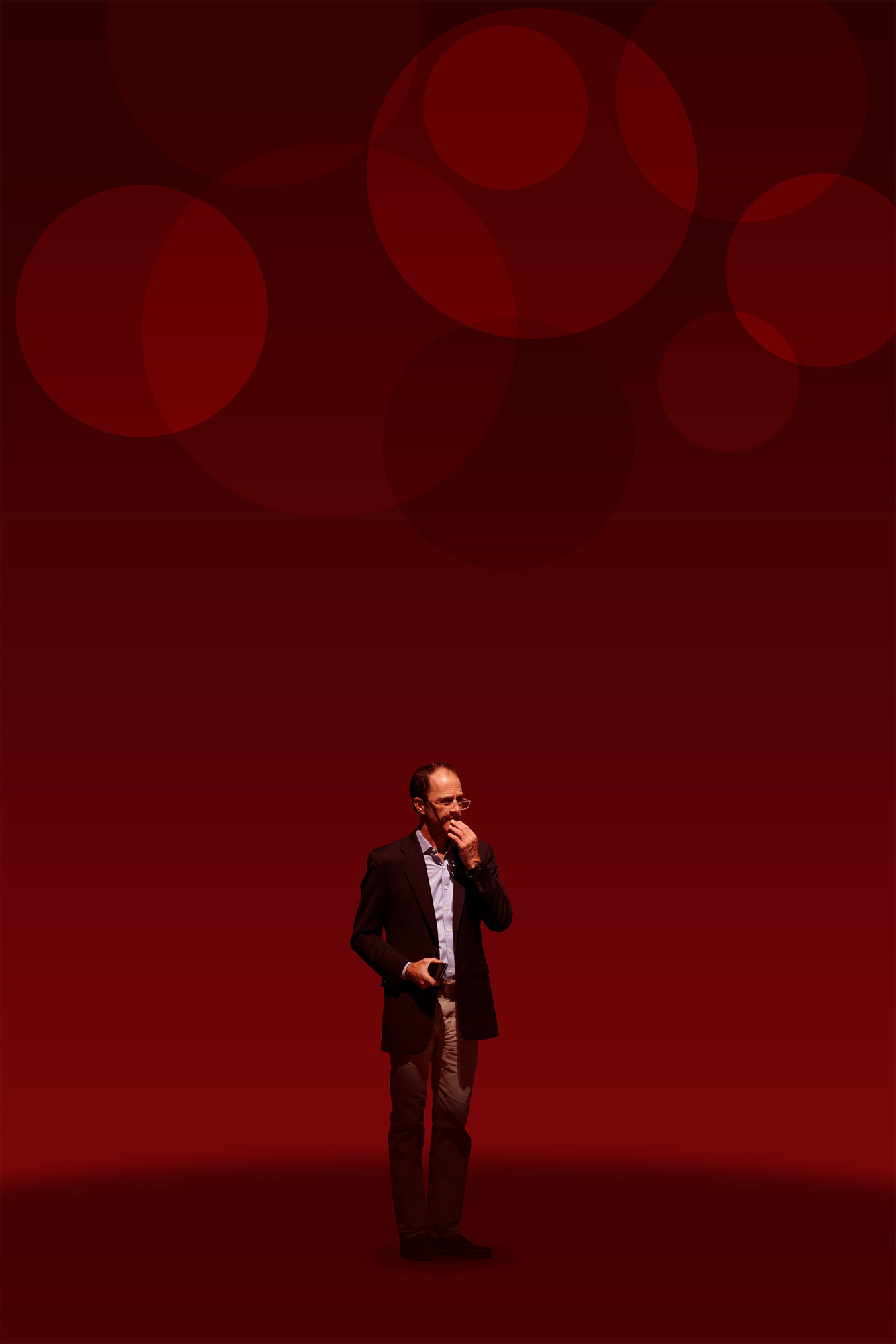 This is a color digital photograph featuring a person isolated in a significantly modified background. The image is dominated by a black and red color palette, and graphics that reference eonomic indicators. While the image started with street photography, the additional colors and graphics tie the image to economic conditions.