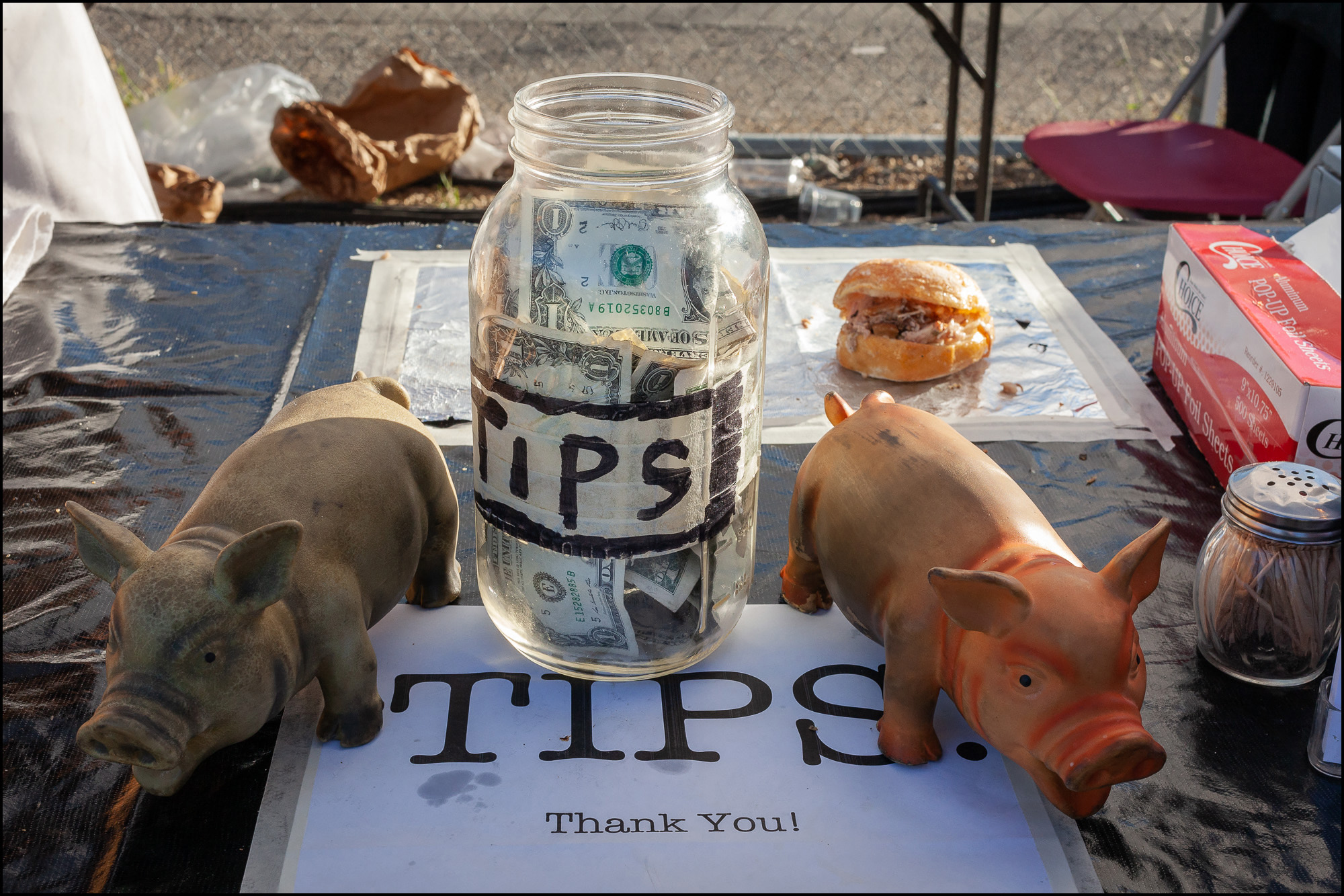 Photo: tip jar with decorative pigs on either side.